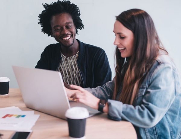 Two people meeting and laughing about their amazing jokes